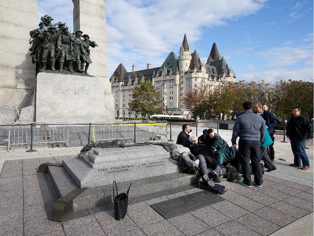 police-bystanders-and-soldiers-aid-a-fallen-soldier-at-the.jpg